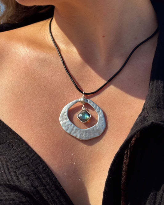 Handmade Aegean Necklace featuring hammered gold or silver pendant on adjustable black or brown leather cord, with optional hand-wrapped gemstone.