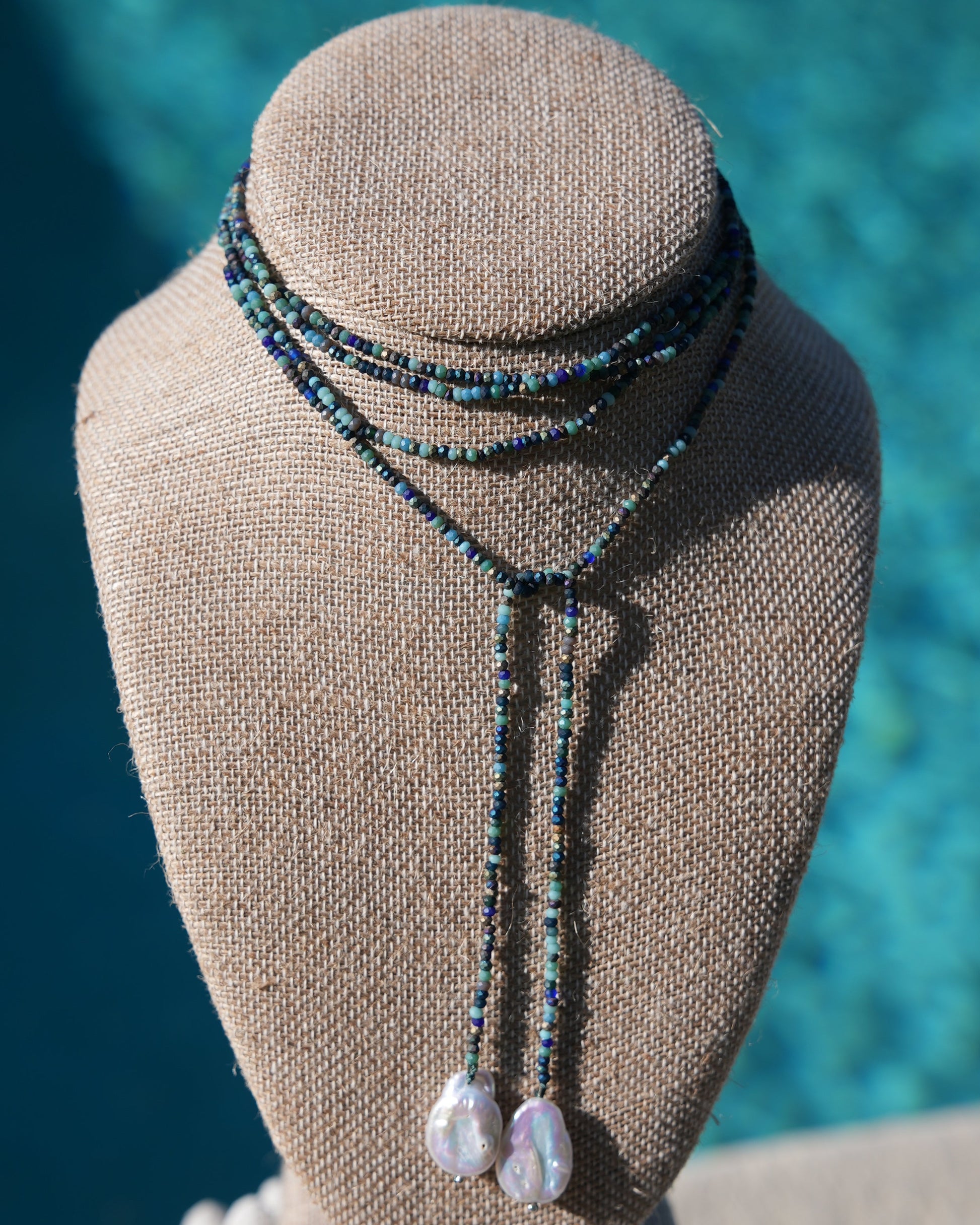 Handmade Lola Necklace featuring mixed blue beads and natural freshwater pearls, lariat style for versatile wear, each necklace unique.